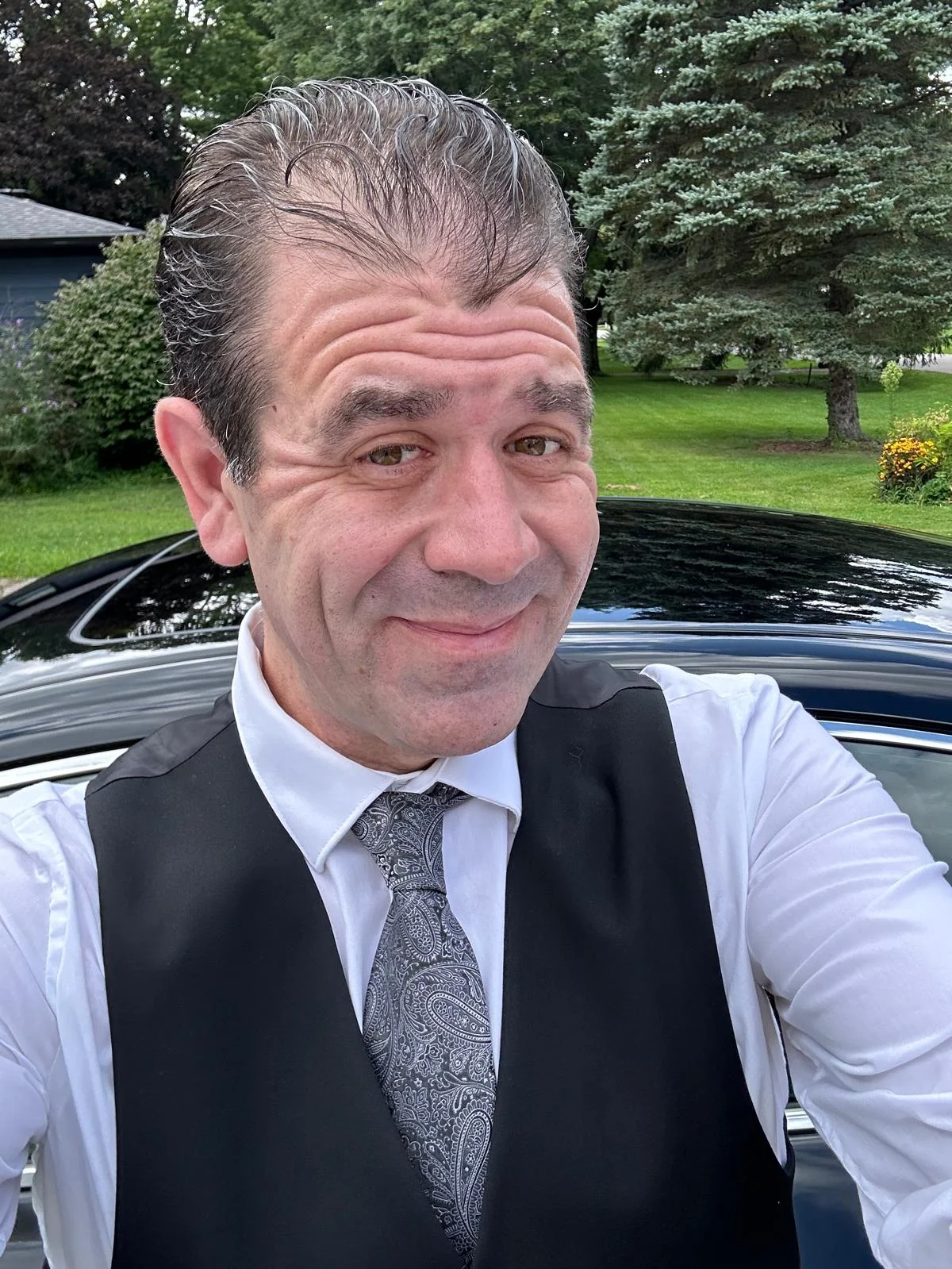 Brian Tort outdoors in formal attire